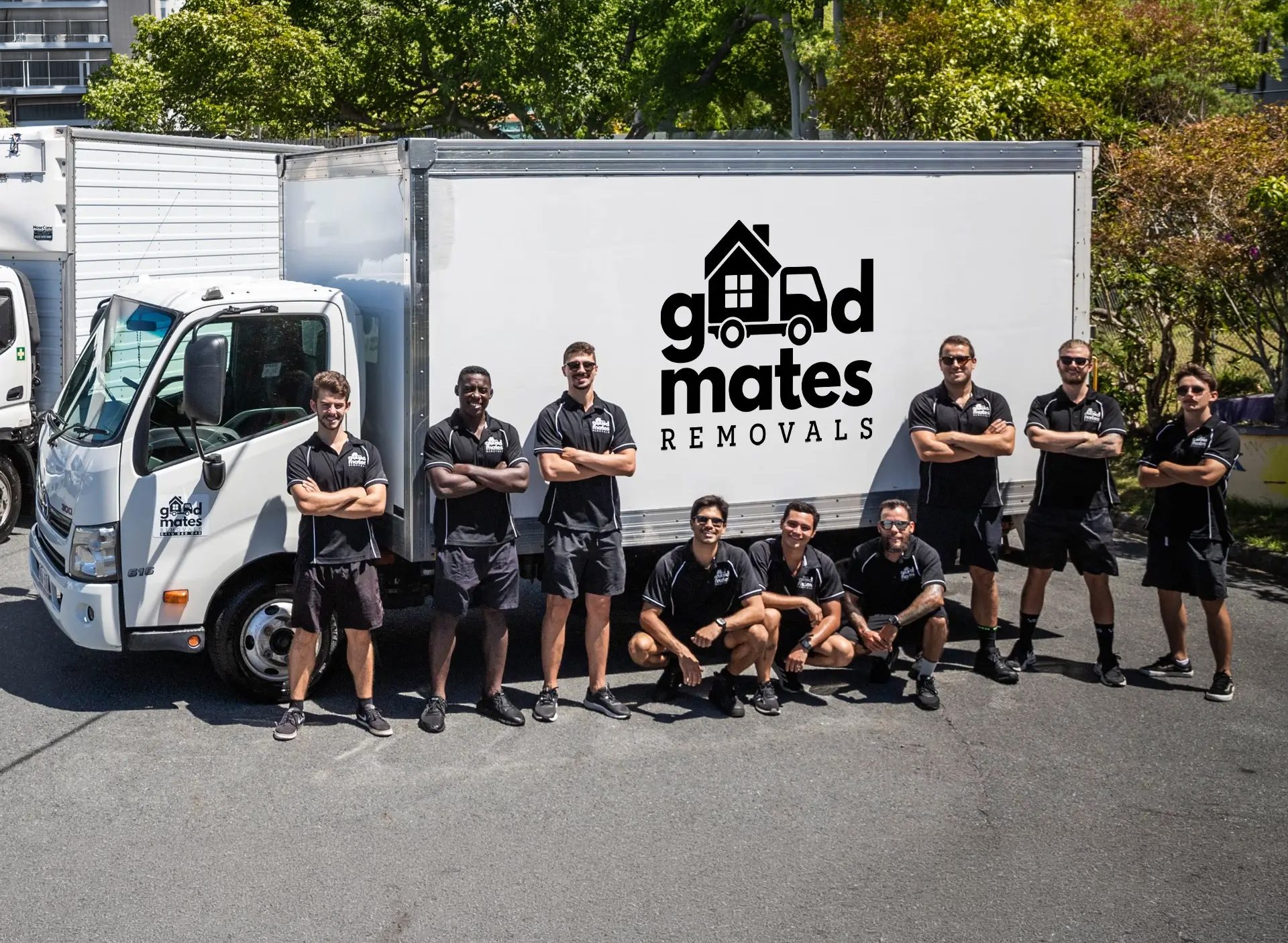 Good Mates removals team standing beside their trucks